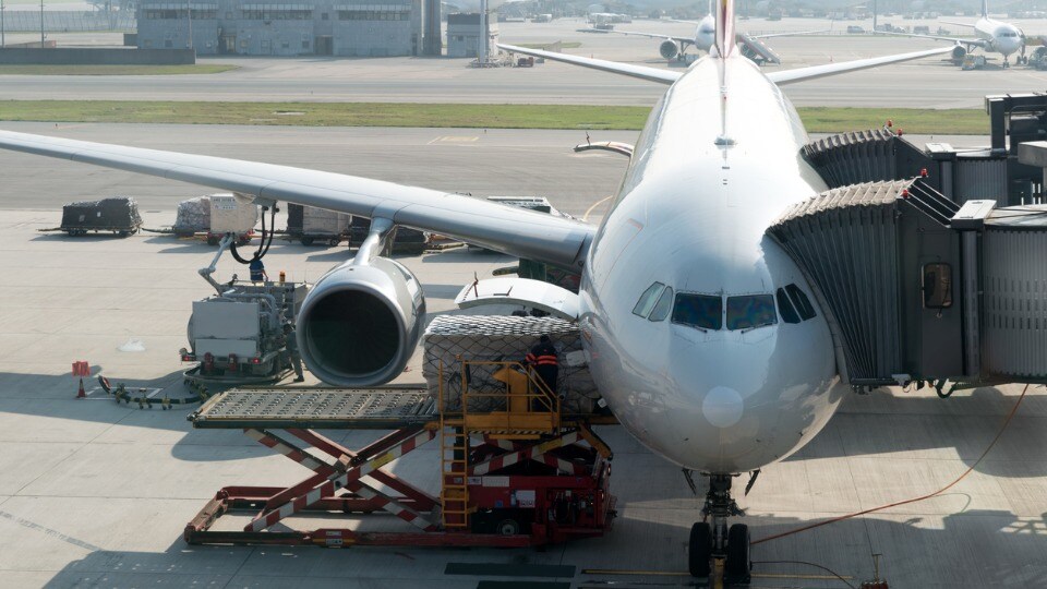 Loading cargo on plane in airport before flight