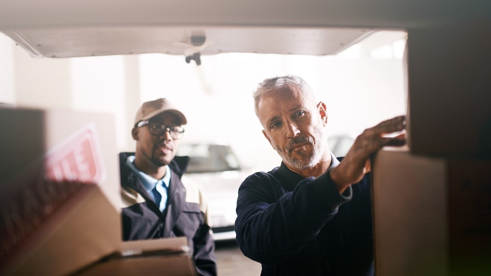 Security check on packages being loaded onto delivery van