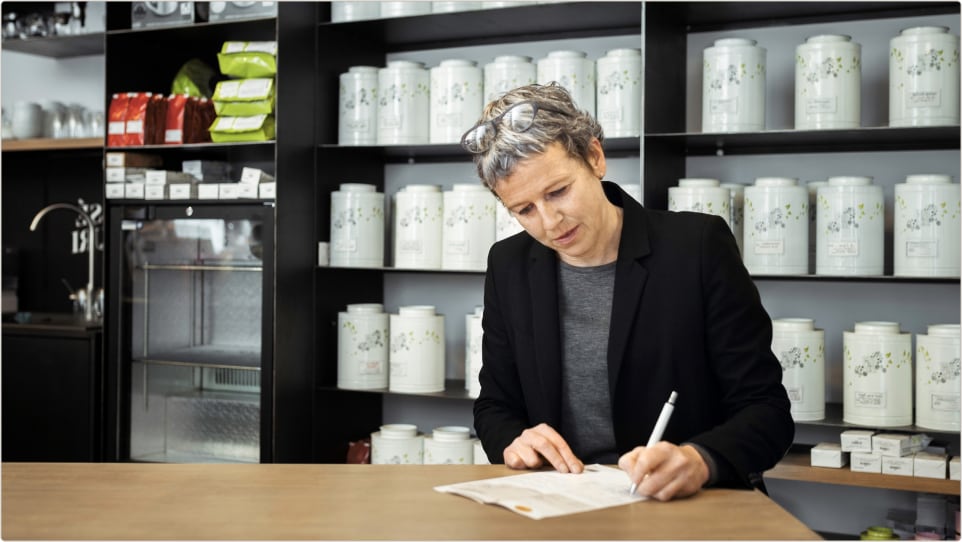 Female shop owner taking notes