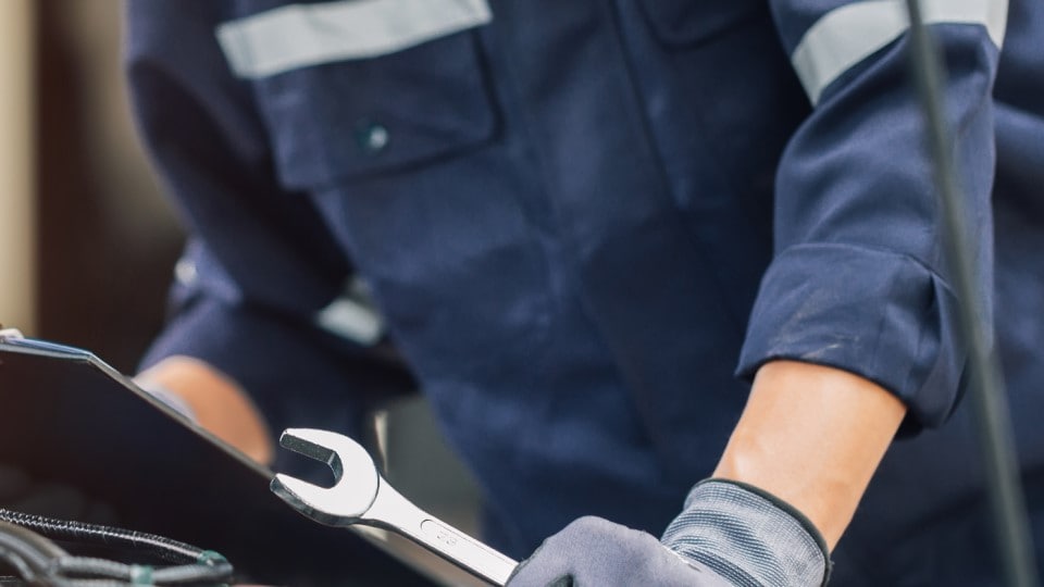 mechanic holding a wretch while diagnosing the problem