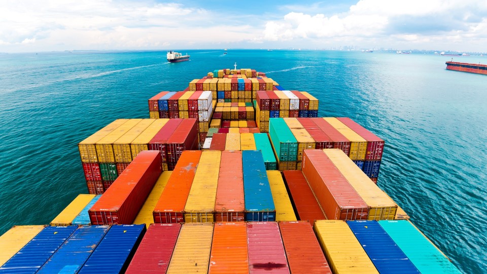 colorful ocean containers on cargo ship in the middle of the ocean