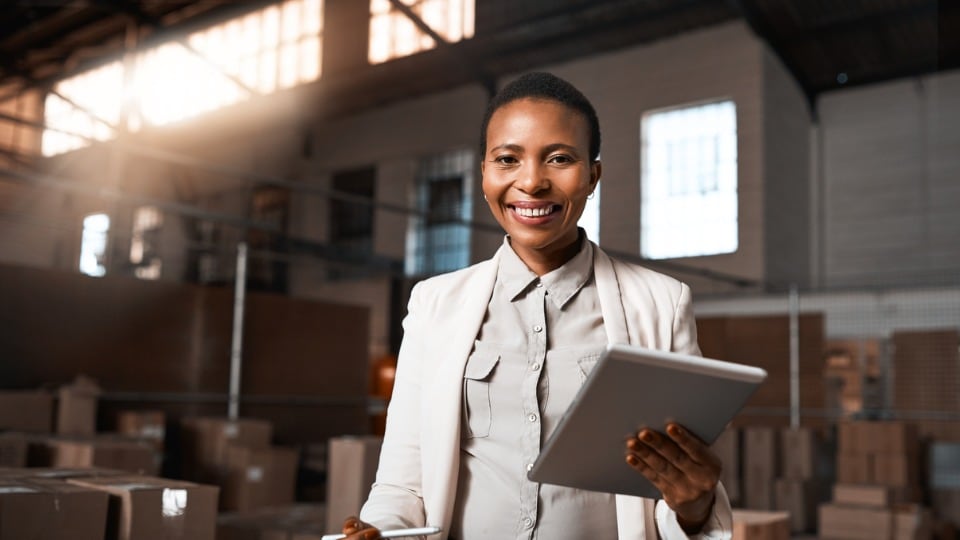 factory manager using a digital tablet in a warehouse