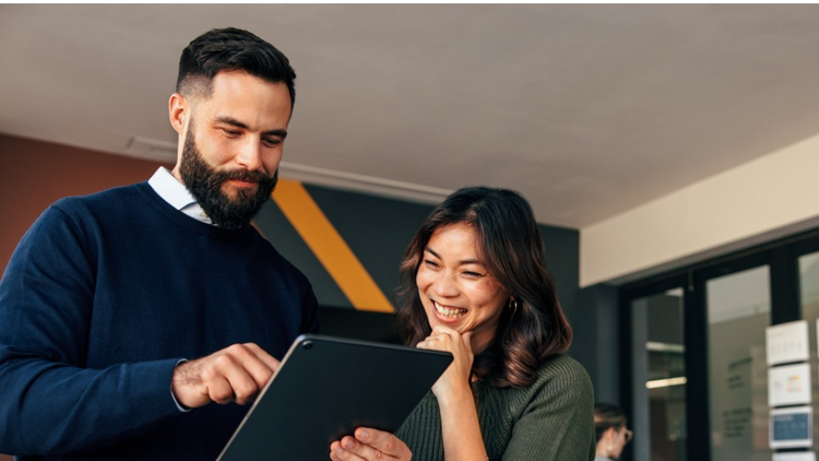 two professionals looking at a tablet